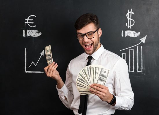 happy-young-bearded-man-glasses-holding-bunch-money_171337-10357